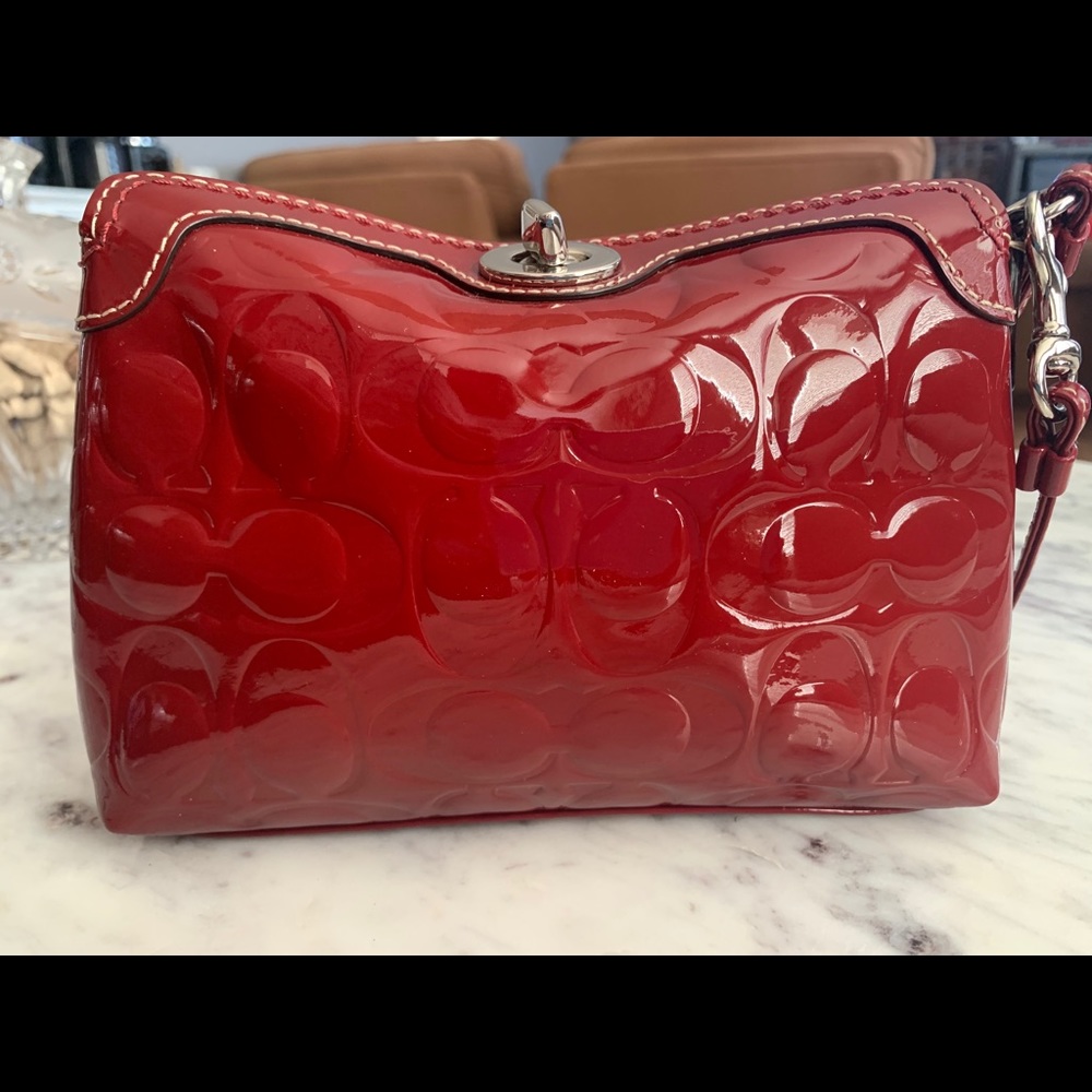 Coach wristlet in fun patent cranberry red.